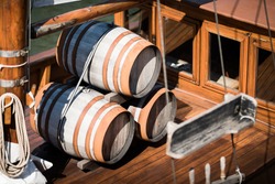 Wooden barrels on the deck of a small sailing ship 