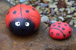 Idea for garden, yard decoration. Sea ​​stones painted like a ladybug. 