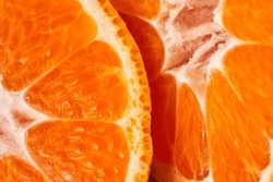 sliced sweet ripe tangerine close-up , macro photo , delicious and healthy citrus fruit , vitamin concept