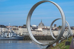 View of Nantes,France.Nantes panorama across Loire River.The Buren metal rings decoration. Sightseeing on Ile de Nantes.Beautiful European cityscape. French urban architecture