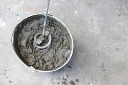 Mixing of concrete mortar.The builder prepares the cement mortar using a construction mixer.Plaster mortar in a bucket.