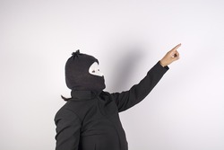 Thief woman standing pointing