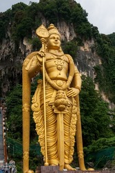 Close up of Murugan Statue (Tugu Dewa Murugga) in Batu Caves, Selangor, Kuala Lumpur. Tallest statue of a Hindu deity in Malaysia made with 300 liters of Gold Paint and 350 tons steel bar.