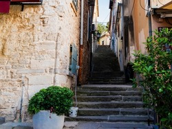 a narrow alley with stairs in a Mediterranean town