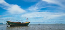 landscape view Small fishing boat parked on the coast of the sea. after fishing of fishermen in a small village It is a small local fishery. Blue sky, white clouds, clear weather, Phala Beach, Rayong