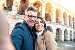 Married couple of tourists taking a selfie portrait visiting Italy - Senior man and woman enjoying weekend vacation - Happy lifestyle concept