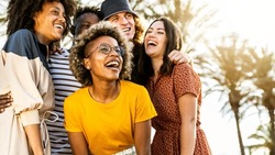 Multiracial young people laughing out loud on a sunny day - Cheerful group of best friends enjoying summer vacation together - Human resources, youth lifestyle and summertime holidays concept