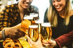 Happy friends cheering beer glasses bar brewery pub - Young people celebrating happy hour at bar table - Teenagers dining together - Beverage lifestyle concept