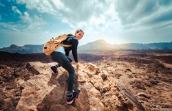 Portrait of a happy woman hiker standing on the top of mountain ridge against mountains - Sport and healthy lifestyle concept