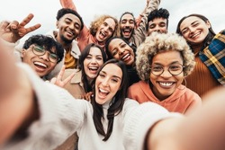 Big group of friends taking selfie picture smiling at camera - Laughing young people celebrating standing outside and having fun - Portrait photography of teens guys and girls enjoying vacation