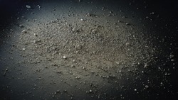 Gravel and powder on black background, abstract texture