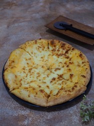 mozzarella cheese pizza. a savory dish of Italian origin, consisting of a usually round, flattened base of leavened wheat-based dough topped with mozarella cheese. grainy textured and gritty line