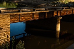 Old rusty bridge over South Para water reflections
