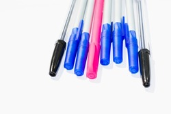Ballpoint pens. Choice of handles. Colored pens. Ink pens for writing. The pens are on the page of the notebook. Stationery concep