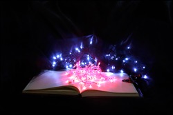 Magical Book of Akashic Records with pretty lights and dark mysterious background