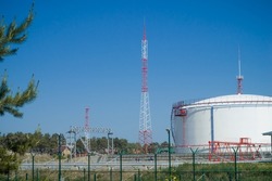 A large oil storage facility with tanks for storing oil and fuel. Storage tank terminal. Selective focus