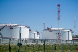 A large oil storage facility with tanks for storing oil and fuel. Storage tank terminal. Selective focus