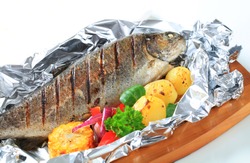 Grilled trout on aluminum foil
