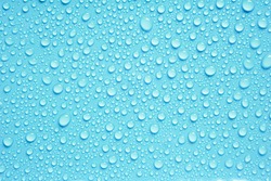 Beautiful big water droplets on the light blue background.