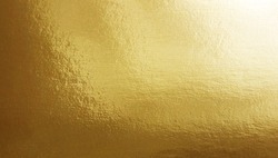 Gold foil gradient texture background with uneven surface     