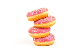 Donuts with strawberry icing and multicolored sprinkles, isolated on a white background. Traditional sweet pastries. Place for text.