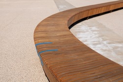 contemporary bench in wavy wood with blue iron details
