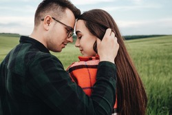 Young Beautiful Couple Hugging Outdoors in Field
