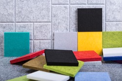 Samples of acoustic panels in red, green, black, yellow and blue colors