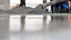 Construction worker Concrete pouring during commercial concreting floors of building in construction site and Civil Engineer
