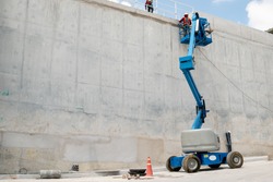 boom lift at water concrete tank construction site