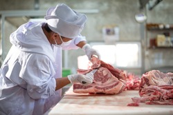 Butcher working in meat industry factory good product of food