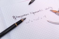 pythagorean trigonometric identity in the notebook next to the pen and Compass drawing tool