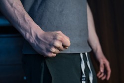 close-up on the fist of an aggressive man. a concept showing violence against people, domestic violence, frustration, irritation and anger