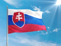 Slovakia national flag waving in the wind against deep blue sky. High quality fabric. International relations concept.