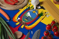 Ecuador flag on fresh vegetables and knife concept wooden table. Cooking concept with preparing background theme.