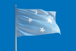 Micronesia national flag waving in the wind on a deep blue sky. High quality fabric. International relations concept.