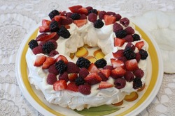 A home made traditional Australian Pavlova dessert with fresh whipped cream and berries