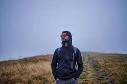 Man hiker hiking in mountain 
autumn weather
mountains wearing cold weather 
Guy portrait lifestyle.