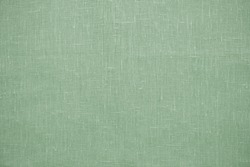 Green linen pastel fabric, background or texture, closeup, top view, horizontal