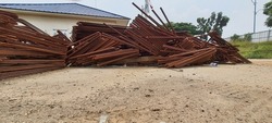 Pile of steel reinforcement that has been bent and ready to be installed in a construction project but has not been installed because the job site is still not ready. It causes the steel to be rusty.