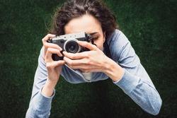 Young photographer girl shooting outdoors, hobbies and leisure concept, top view