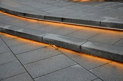 stairs on the square or on the route. stairs on the terrace with backlight. light led strip. light tubes illuminate the bottom of the stairs so that people don't trip over when they go at night