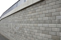 holding a road notch of a bridge forecourt tunnel. retaining wall with concrete grouting is covered with fake, optically prettier wall. fencing with hollow bricks filled with wires, railing,steel