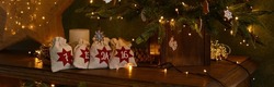 Advent calendar. Christmas bags with gifts on the background of a Christmas tree ,golden bokeh,christmas star. Christmas mood. Banner