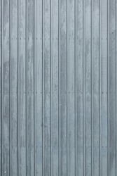 Standing photo of vertical gray-blue wooden planks at a cattle barn in the Netherlands