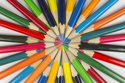 Abstract composition of complementary cirkel with color pencils against a white background