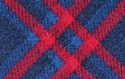 Red and blue plaid tartan design fabric pattern sample. Closeup color swatch directly above.