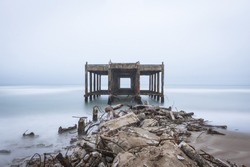 
long exposure pier under a gray sky