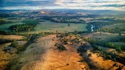 Early morning light over the hills, farmland and Goulburn River between Taggerty and Alexandra in Victoria Australia