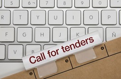 Call for Tenders Written on White Key of Metallic Keyboard. Finger pressing key.